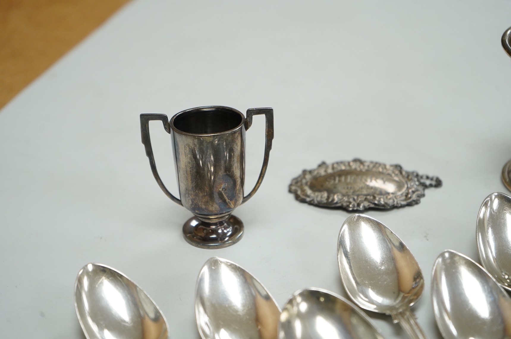A collection of silver to include a set of six George IV silver Kings pattern teaspoons, by William Eaton, London 1824/5, five other items of silver flatware, a small trophy cup, christening mug and wine label, 13oz.